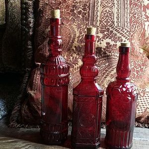Three red decorative bottles
